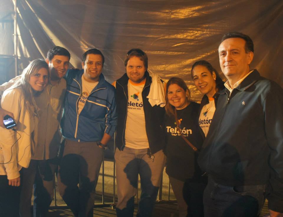 Christian with fellow Teletón organizers at night wearing volunteer vests